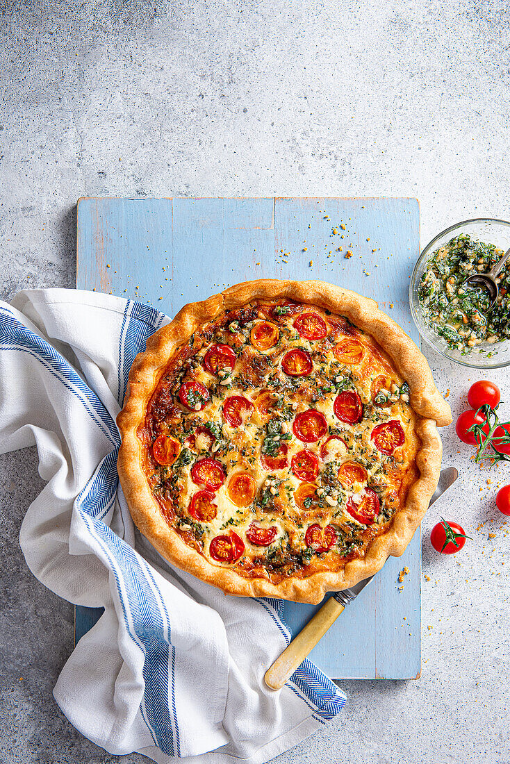 Quiche with roasted cherry tomatoes, homemade pesto and cheese
