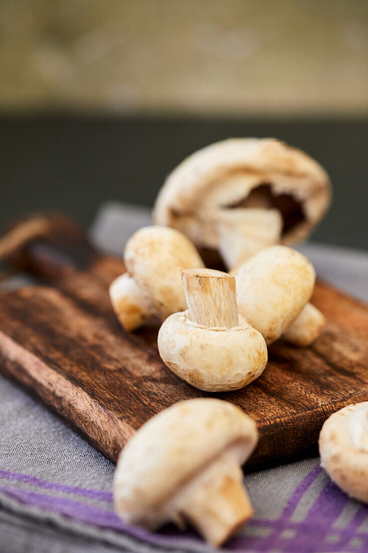 Fresh mushrooms on a wooden cutting board