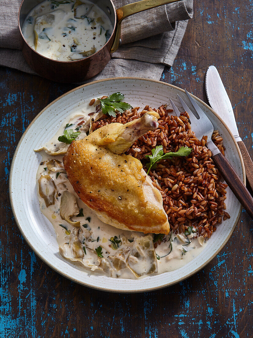 Chicken with creamy artichoke sauce and red rice