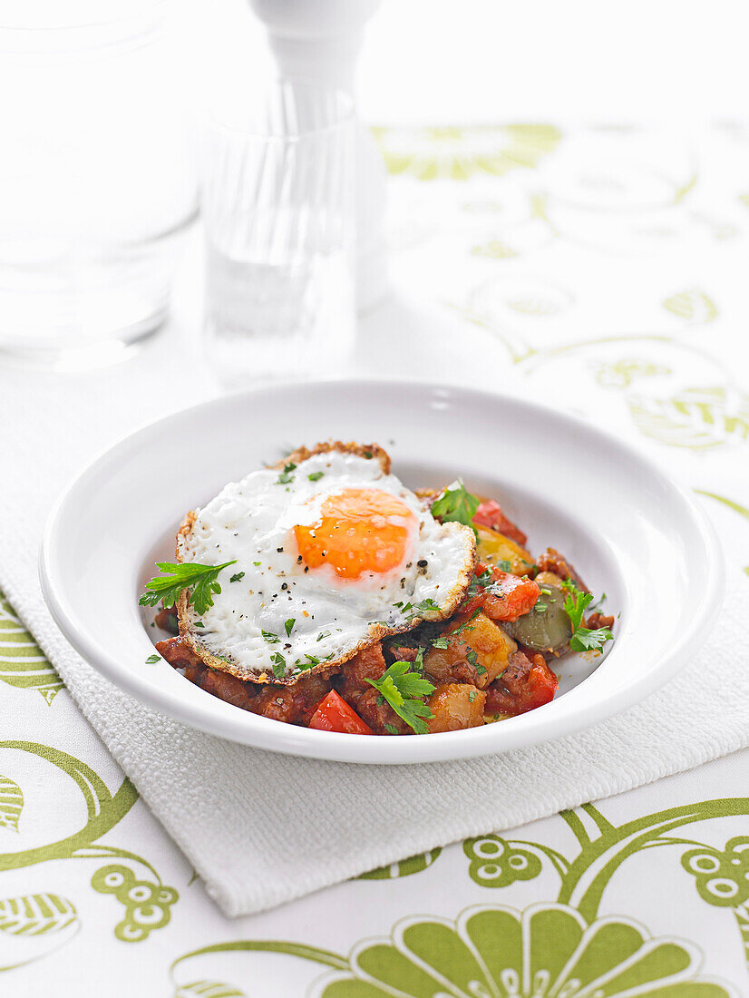 Potato, pepper and chorizo stew with fried eggs