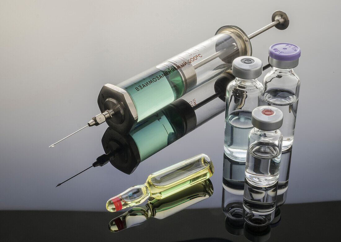Syringe next to vials