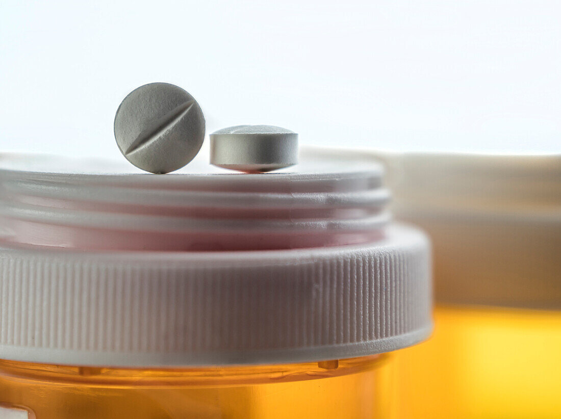 Pills on top of a medication bottle