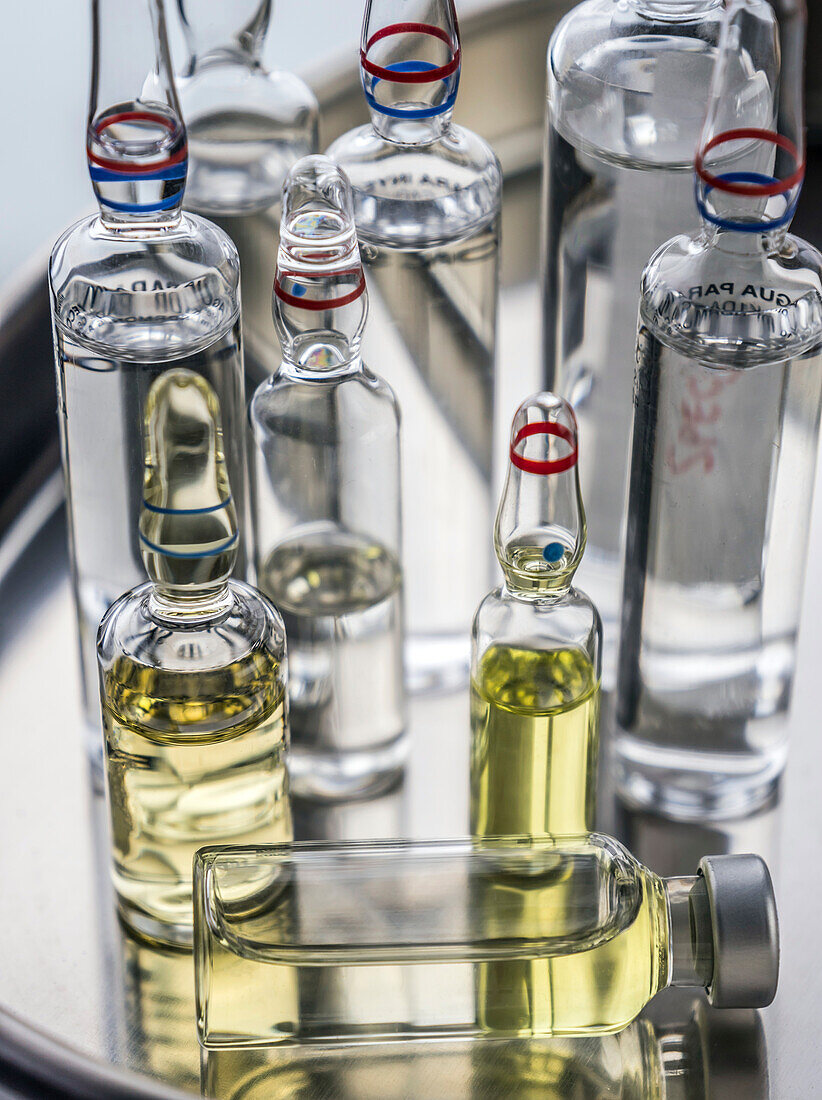 Different types of medical vials on a tray, conceptual image