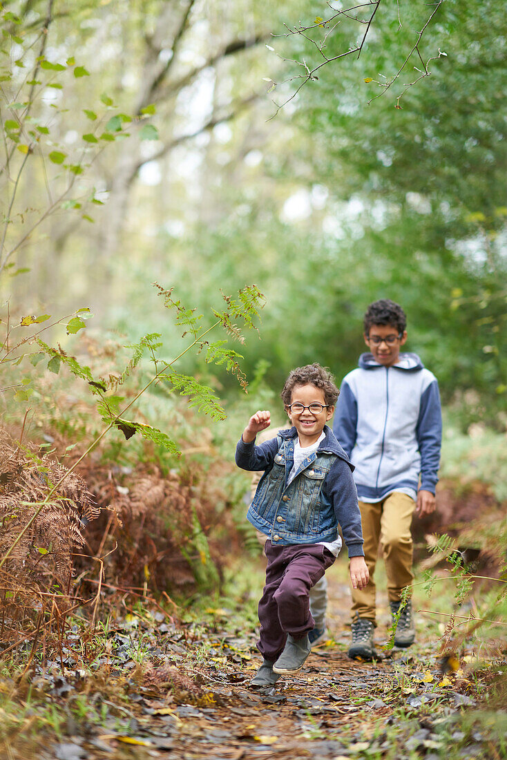 Happy brothers on trail in woods