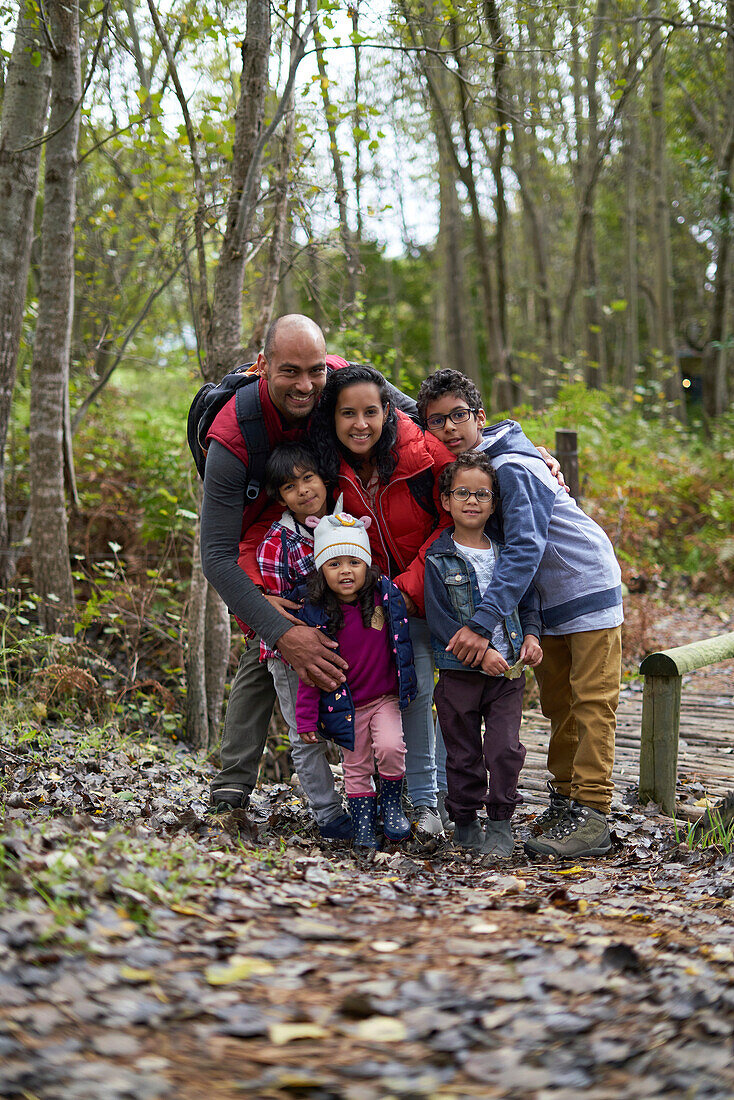 Happy affectionate family hiking in woods
