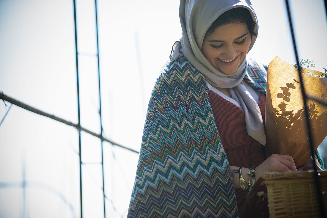 Young Muslim woman in headscarf looking down