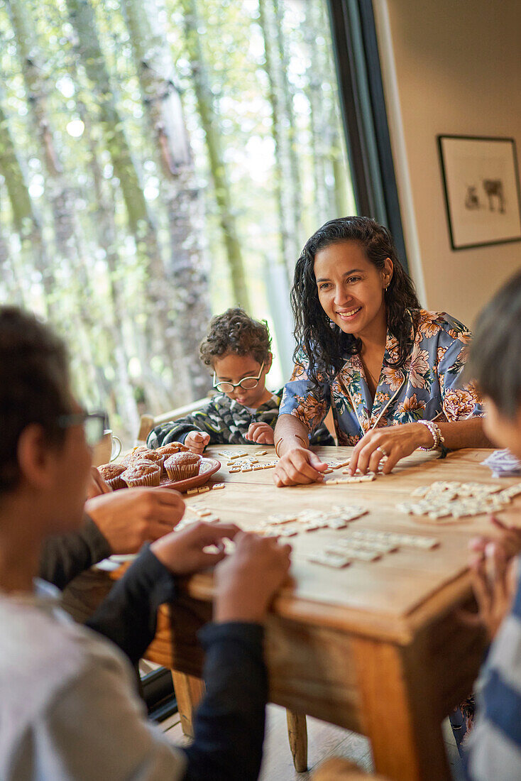 Happy family playing scrabble at dining table