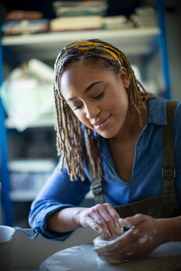 Young woman at pottery wheel