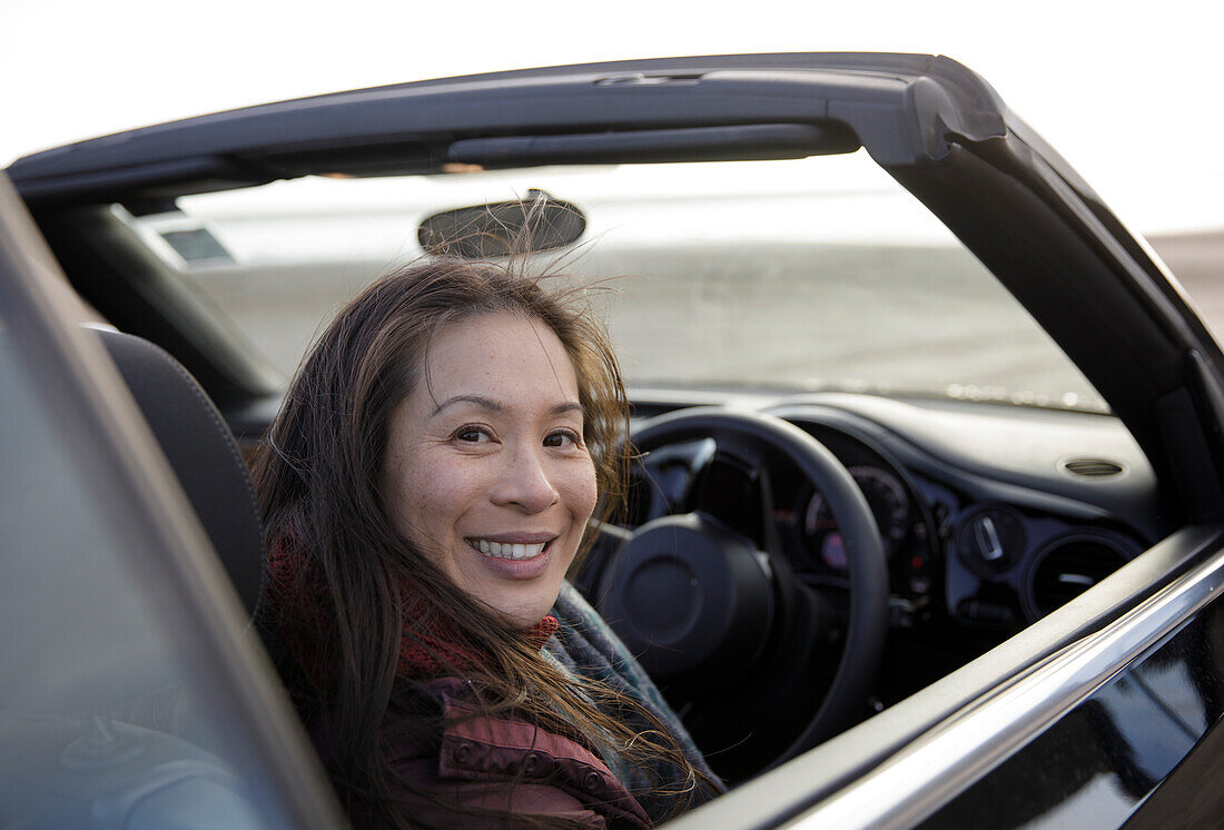 Happy woman in convertible