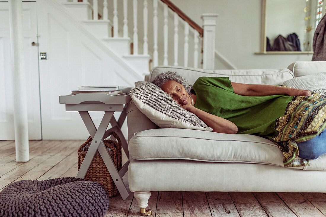 Woman napping on living room sofa