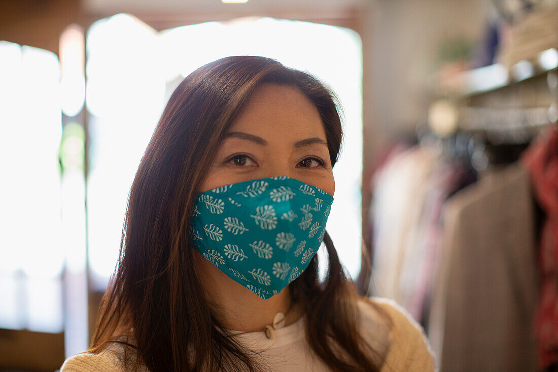 Confident woman wearing face mask in shop