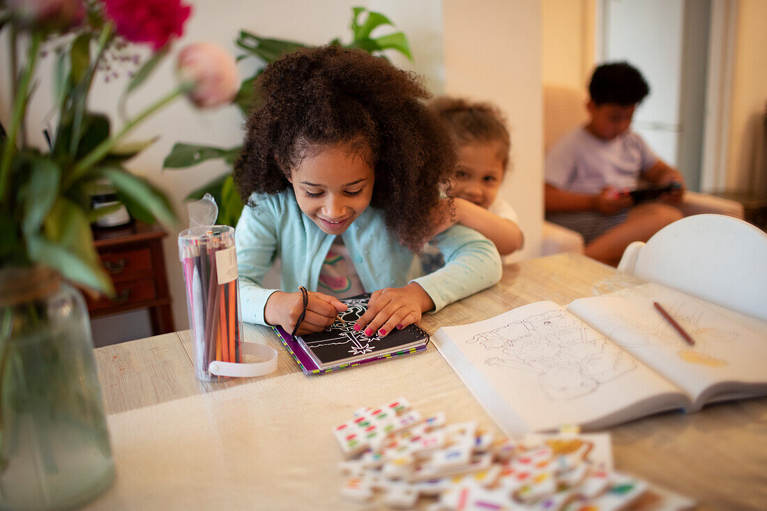 Girl colouring at table