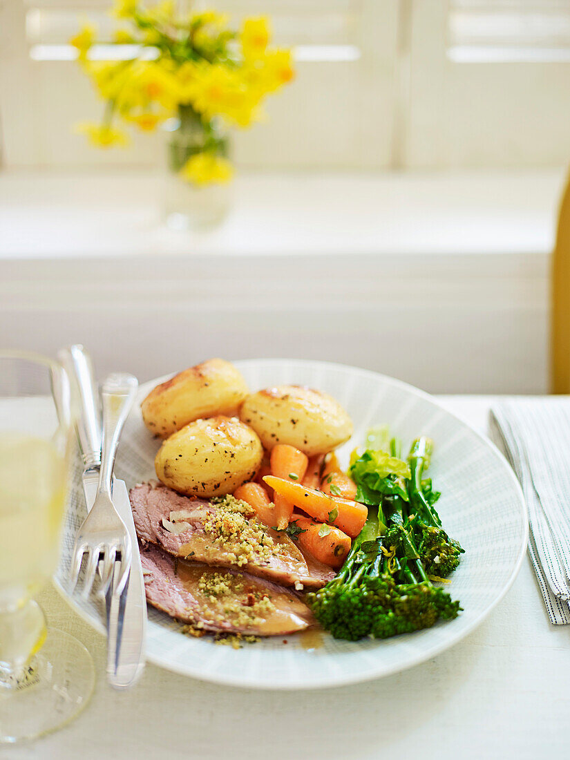 Roast lamb with spring herb crumbs and vegetable garnishes