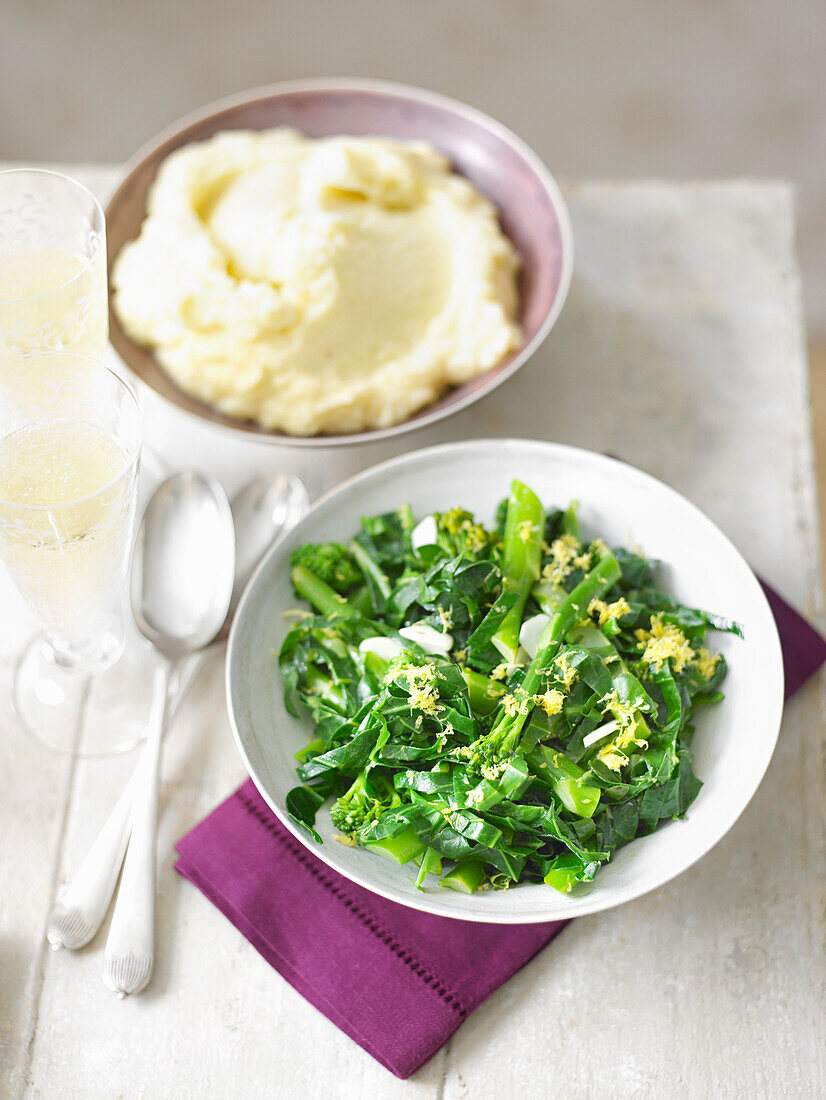 Leafy vegetables with lemon and garlic and mashed potatoes on the side