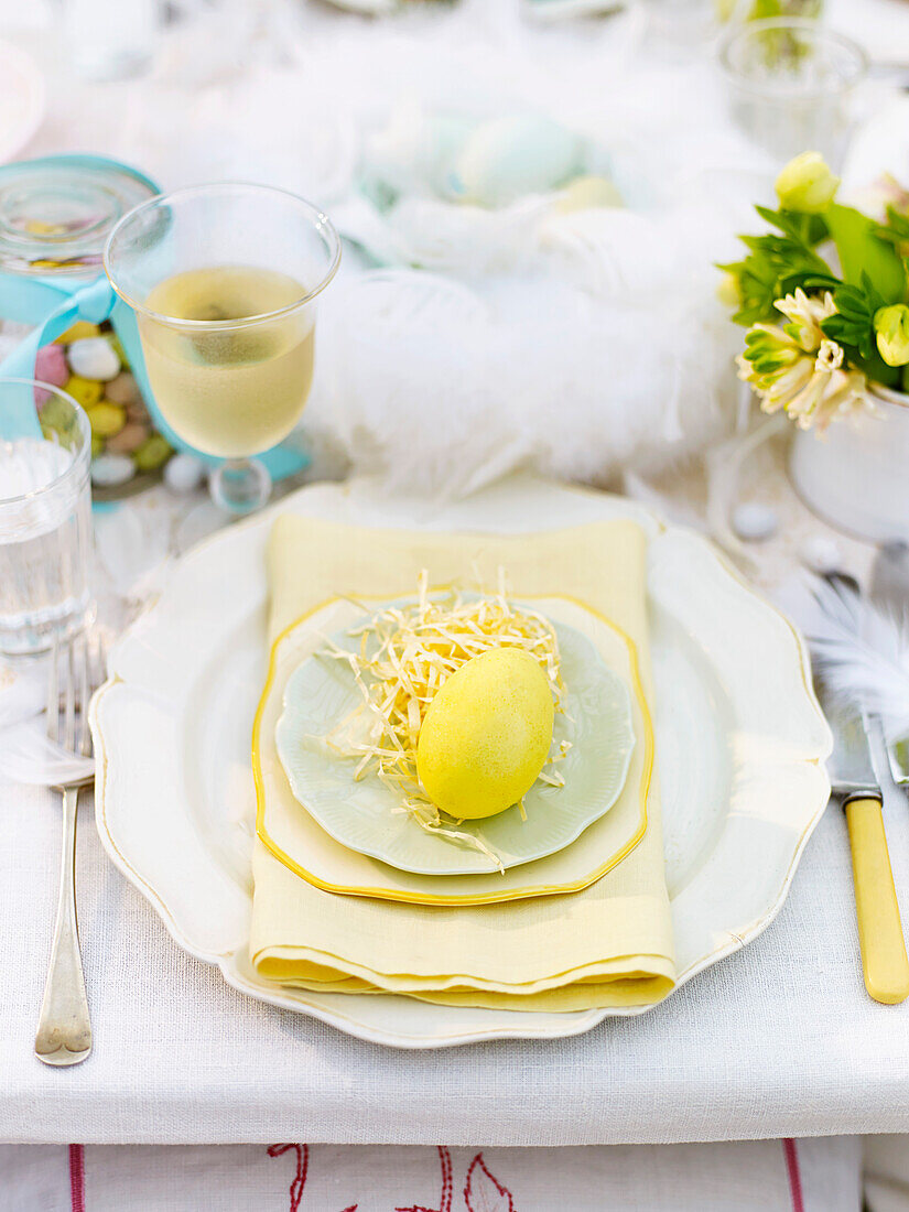Easter place setting with a yellow coloured egg