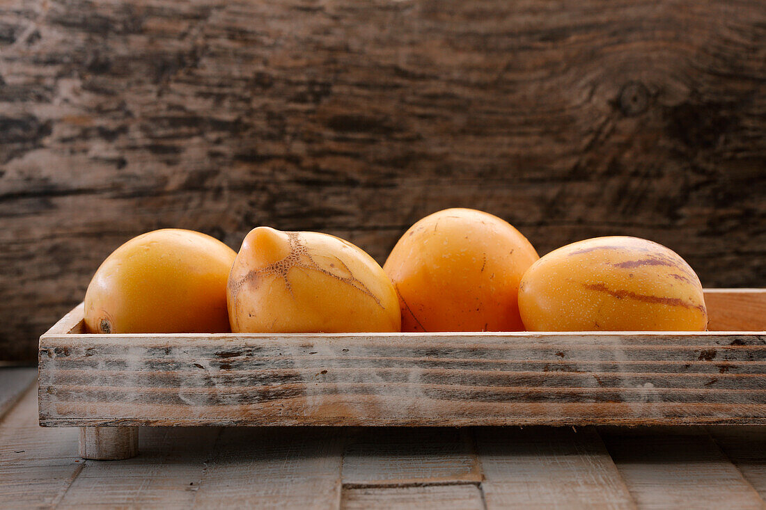 Pepino mini melons on a wooden tray