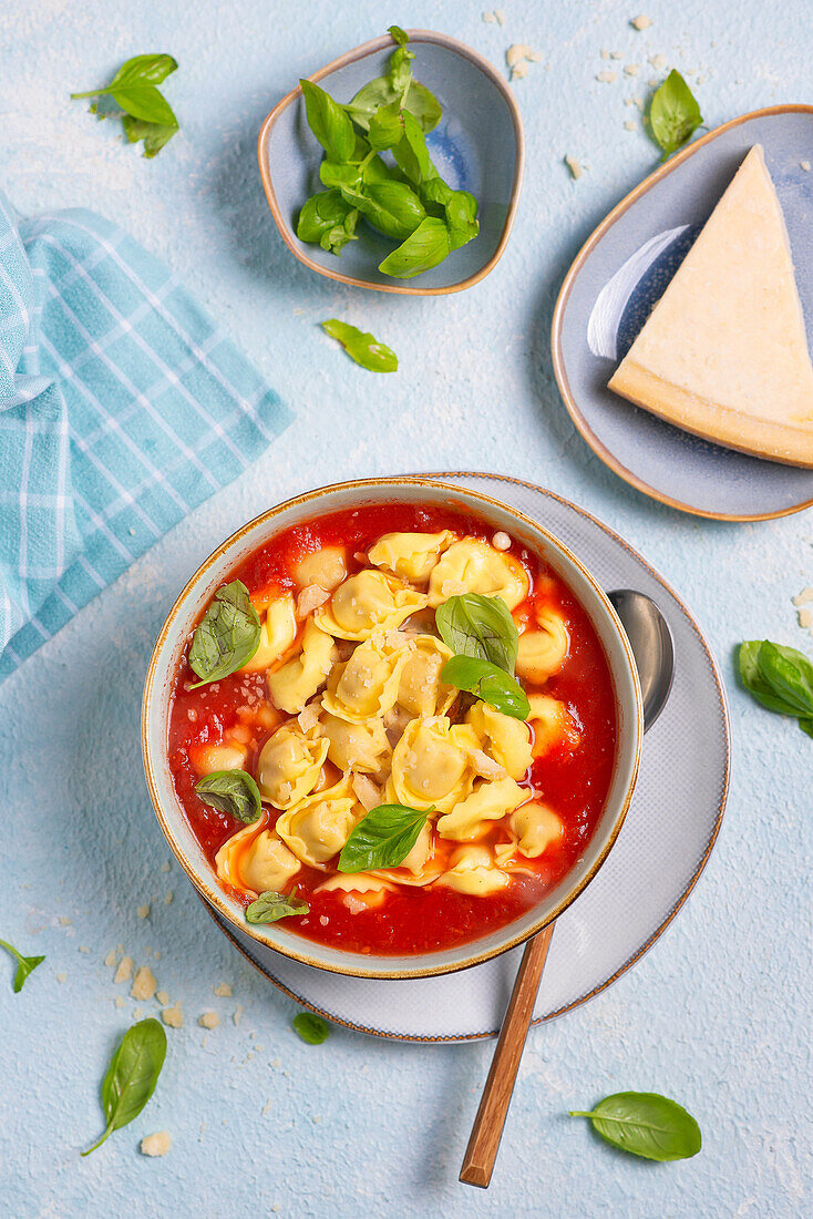 Tomato soup with tortellini, parmesan and basil
