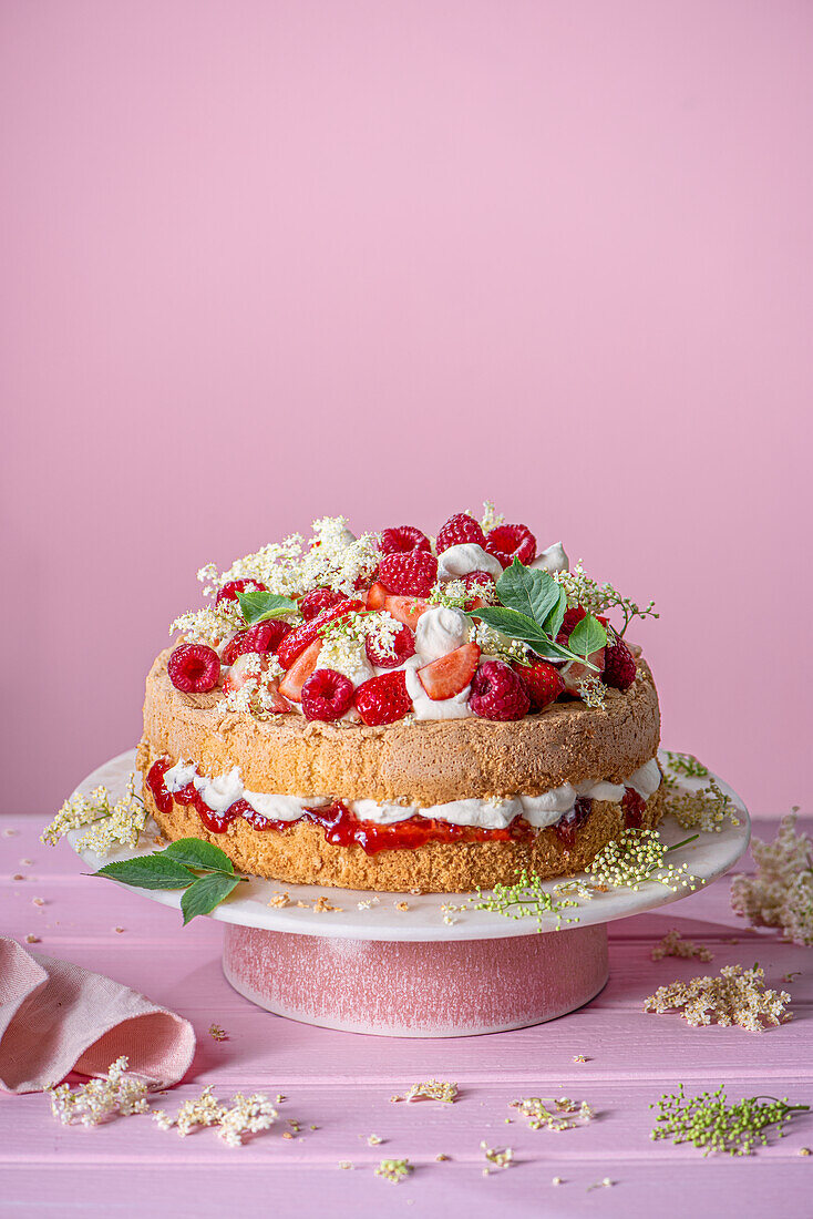 Genoese sponge cake (fat-free) with vanilla cream, strawberry jam, elderflowers, and berries