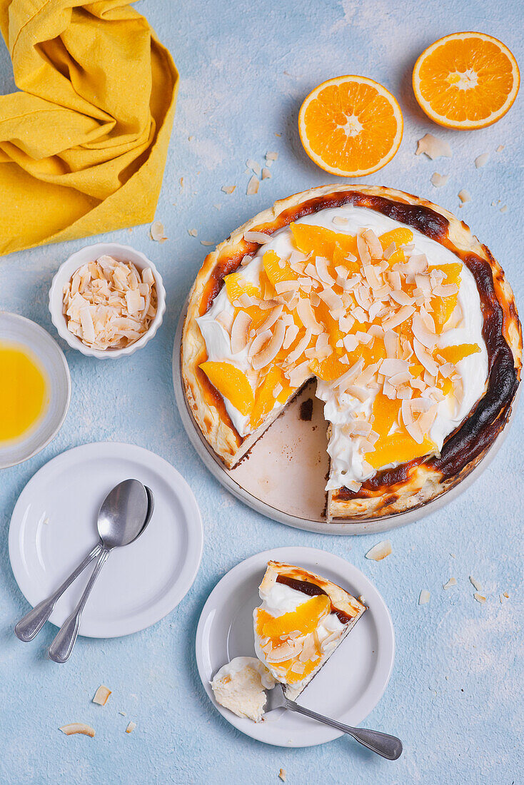 Basque cheesecake with yoghurt, oranges, coconut flakes