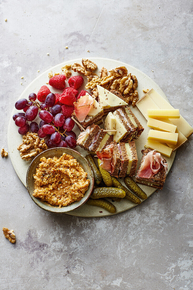 Bread towers with camembert cream served with fruits, nuts and pickles
