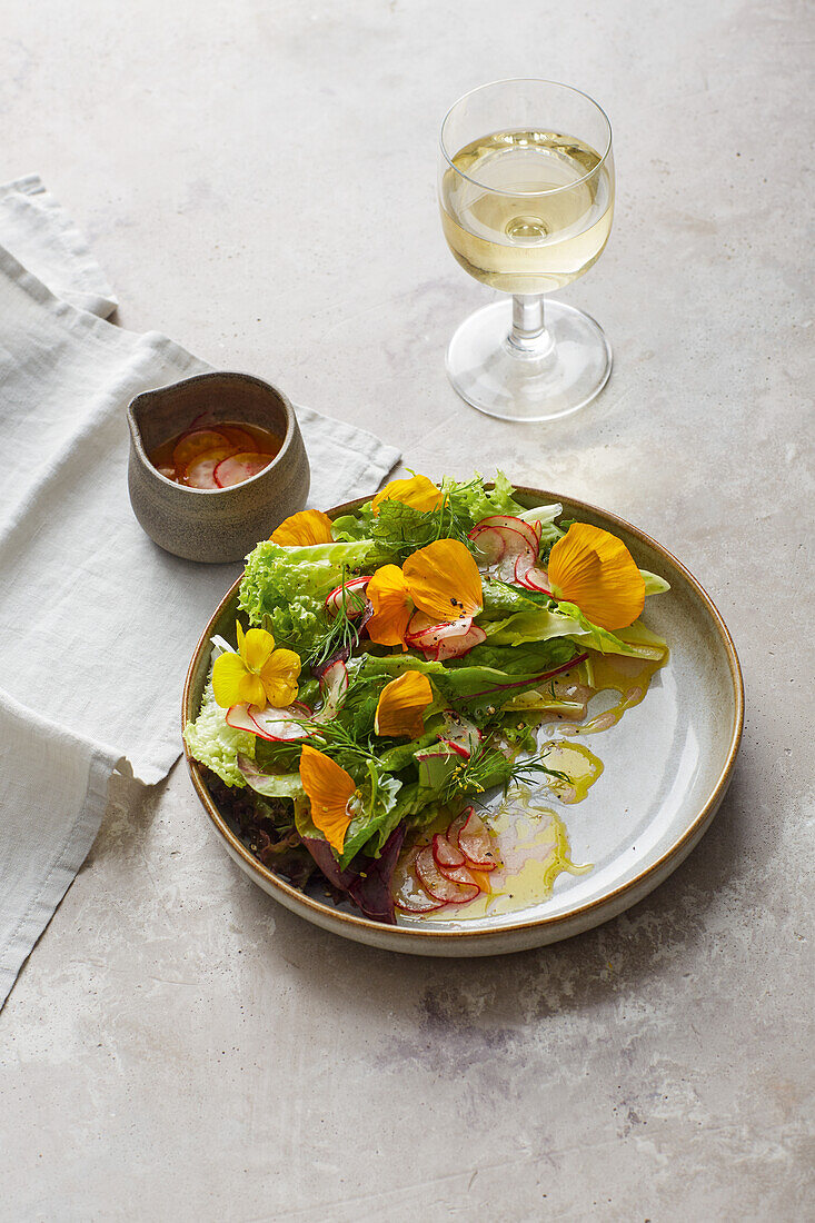 Summer salad with nasturtium flowers and radish vinaigrette