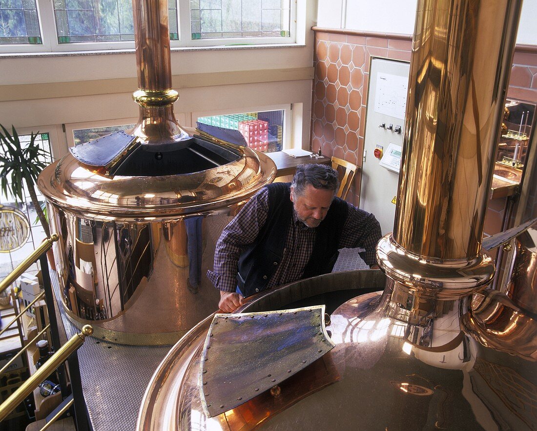 Brewery owner checking the wort in the brewing pan
