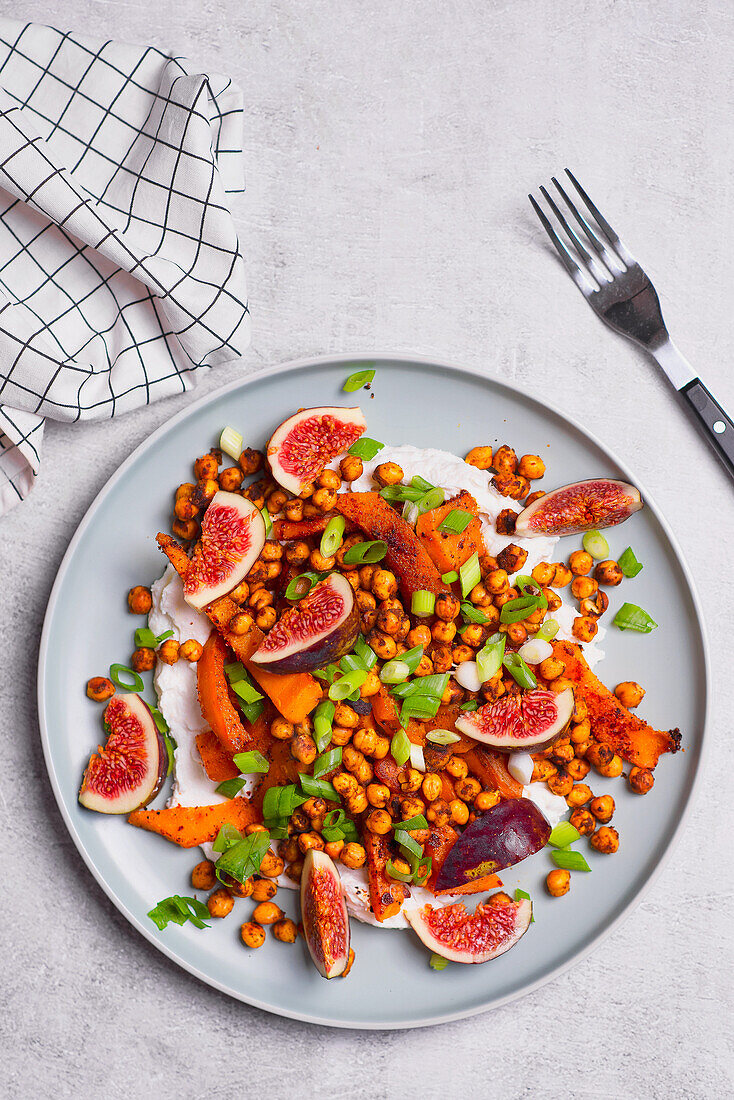 Garlic creamy cheese with baked butternut squash roasted chickpeas fresh figs chopped spring onion