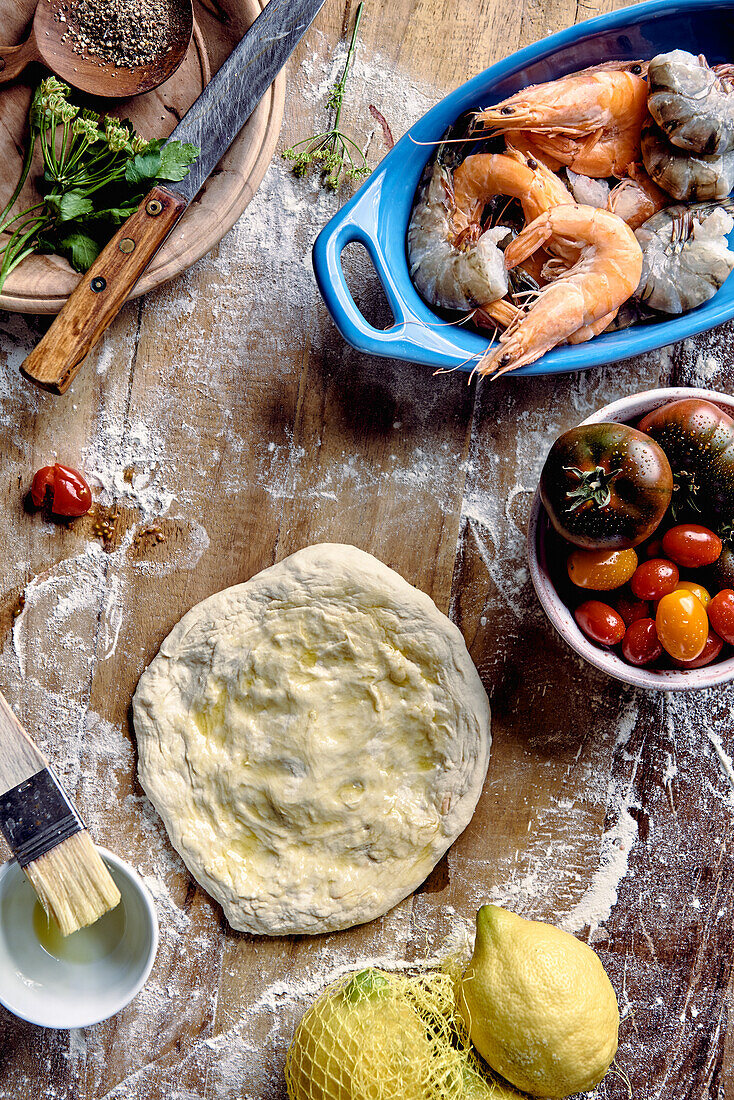 Ingredients for pizza with prawns and tomatoes