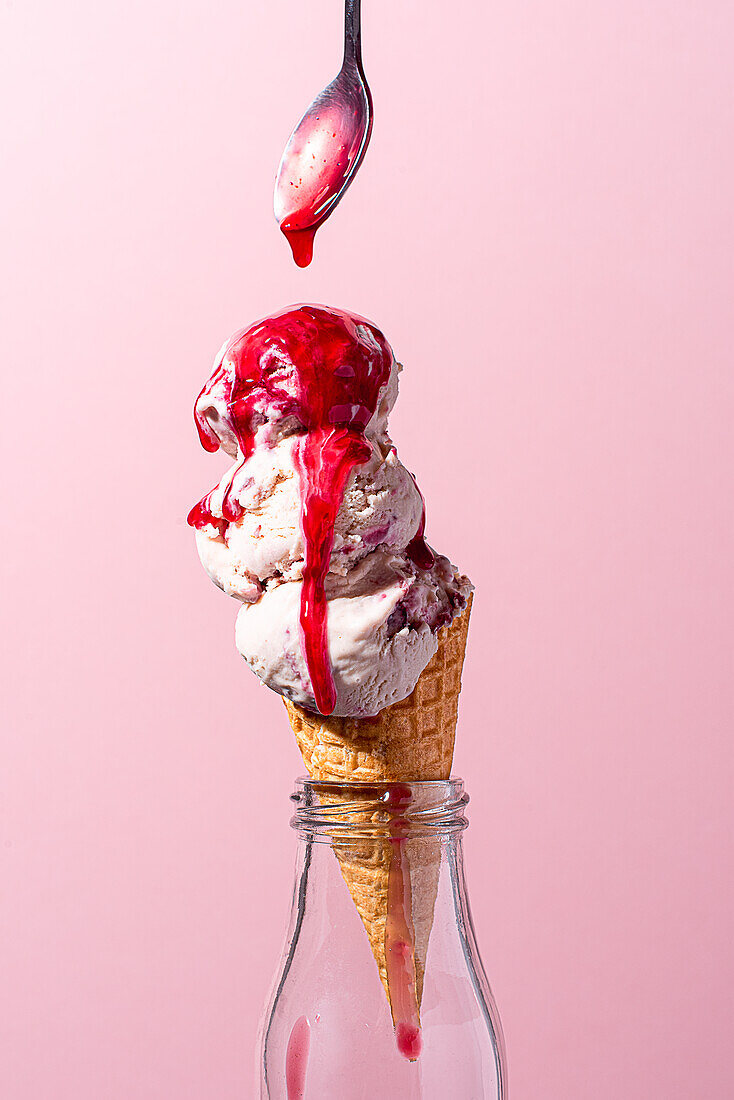 Cherry ice cream in a waffle is drizzled with cherry sauce