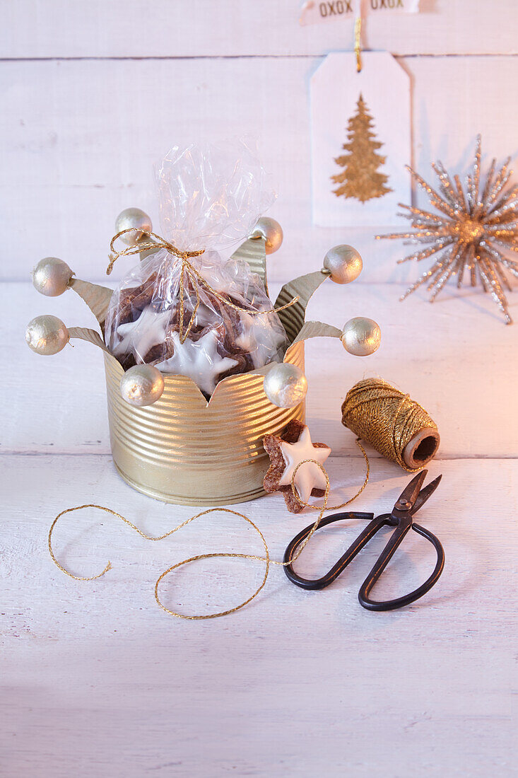 A crown made from a recycled tin can with a bag of cinnamon stars