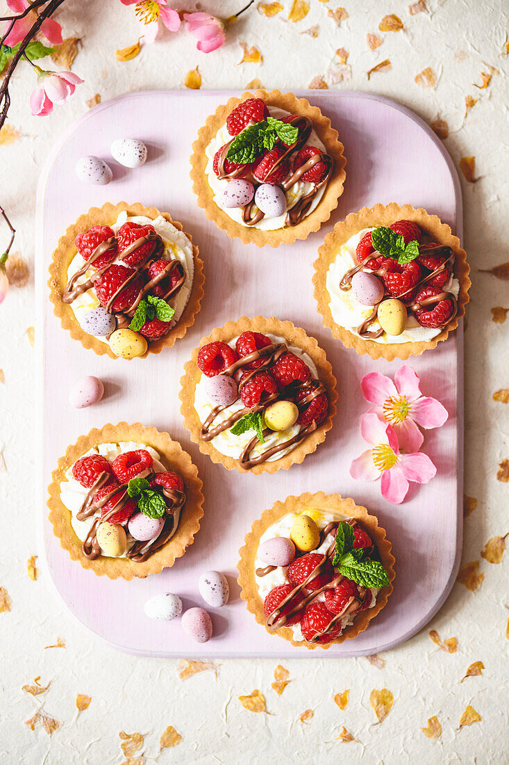 Mascarpone tartlet with raspberries, Easter eggs, and chocolate