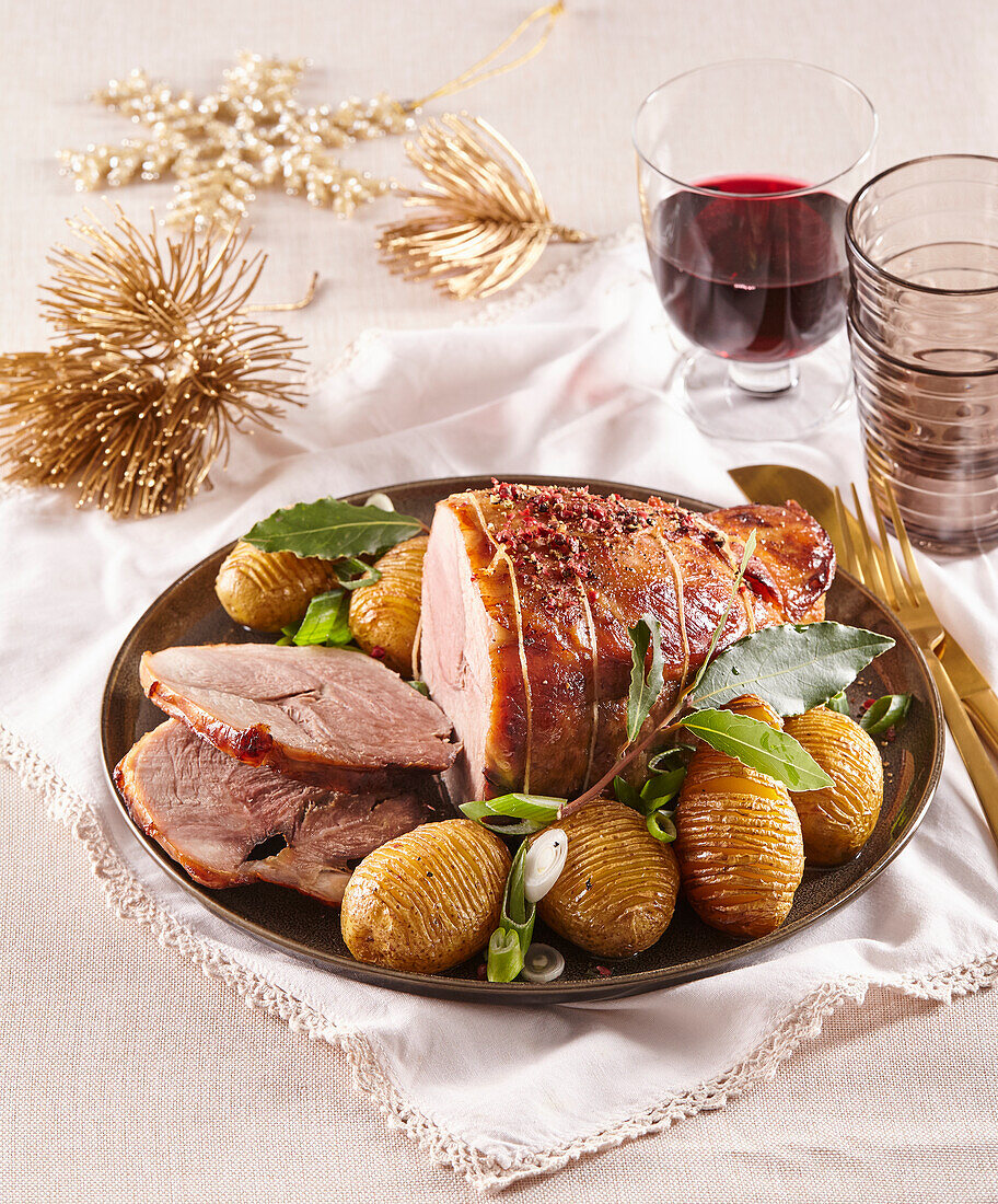 Roasted pork neck with Hasselback potatoes for Christmas