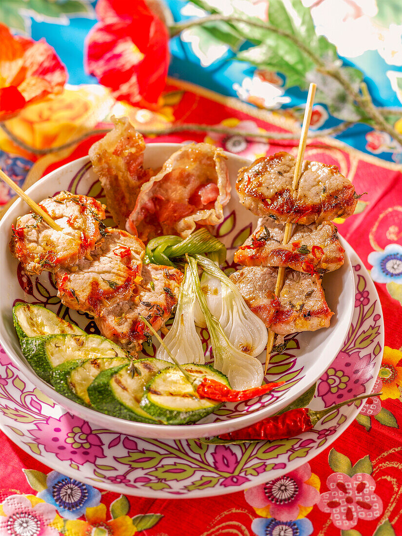 Pork skewers with zucchini, onions, and red peppers