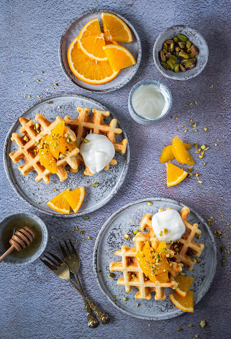 Waffles with orange, yogurt and pistachios
