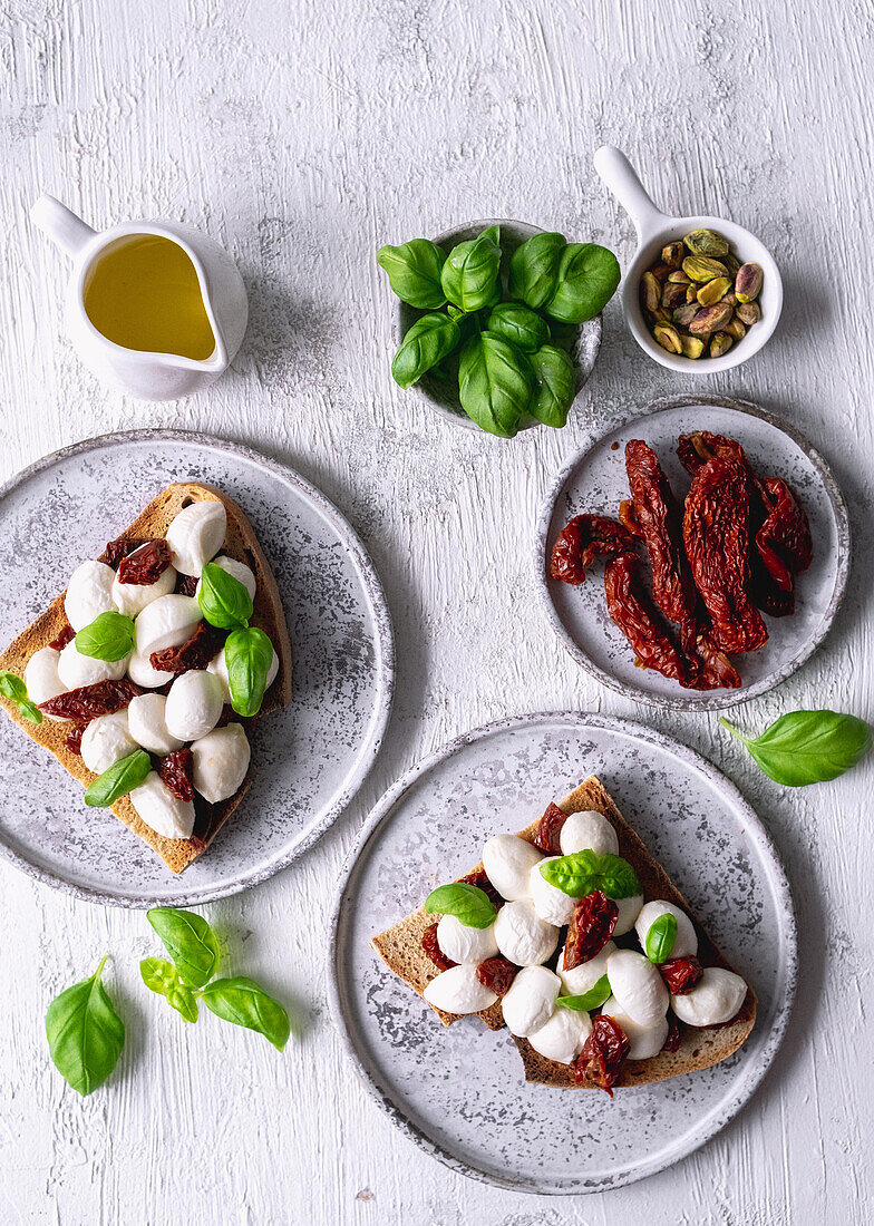 Sandwiches with mini mozzarella, sun-dried tomatoes and basil