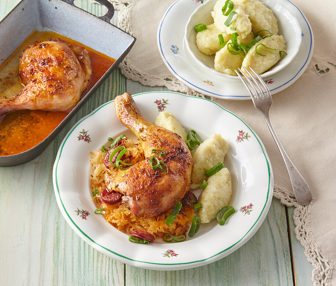 Roasted chicken legs with sauerkraut and potato dumplings