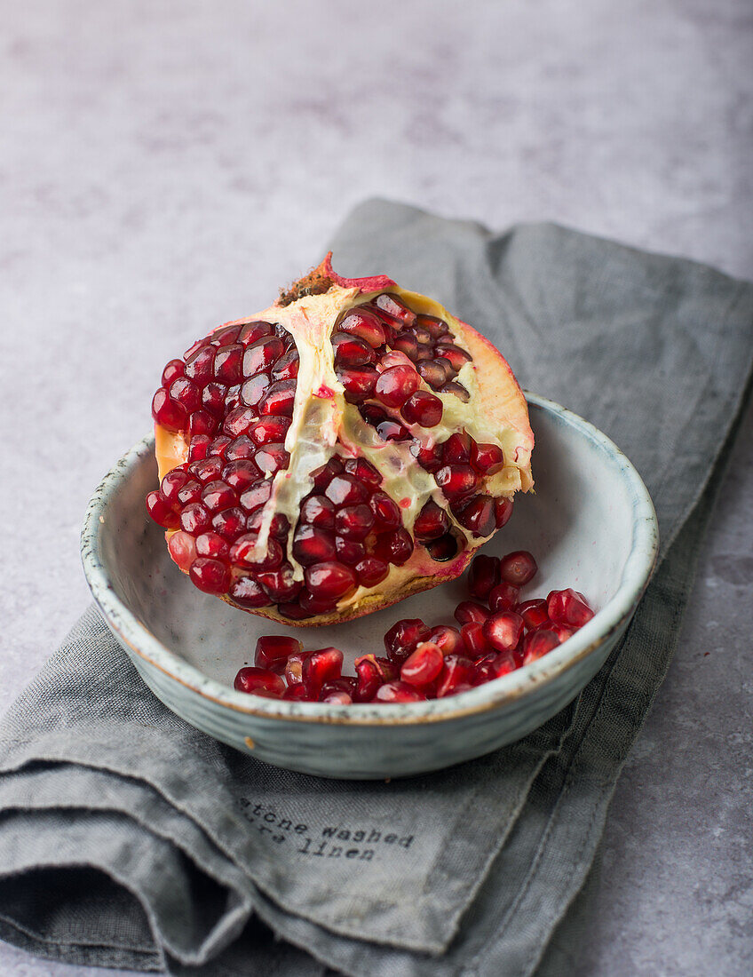 Cracked pomegranate in a bowl