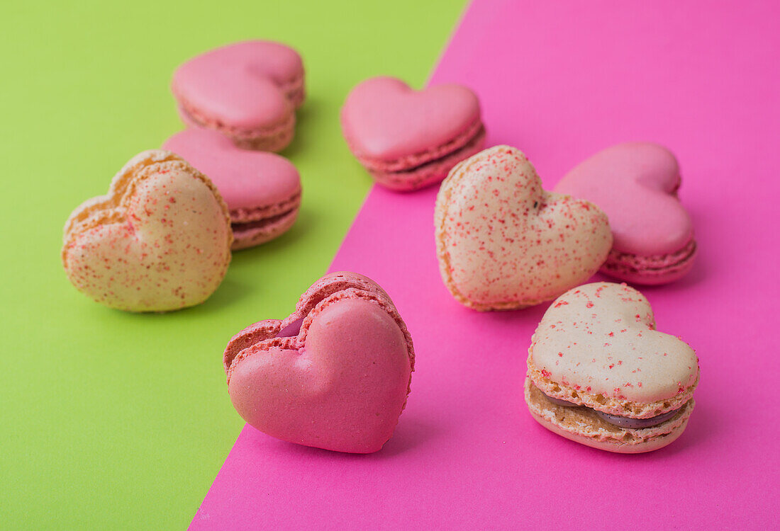 Heart-shaped macarons on a two tone background