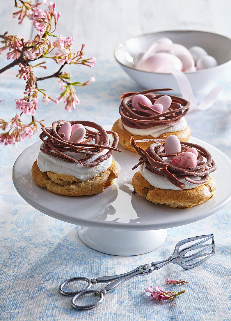 Easter nests with cream, chocolate and Easter eggs