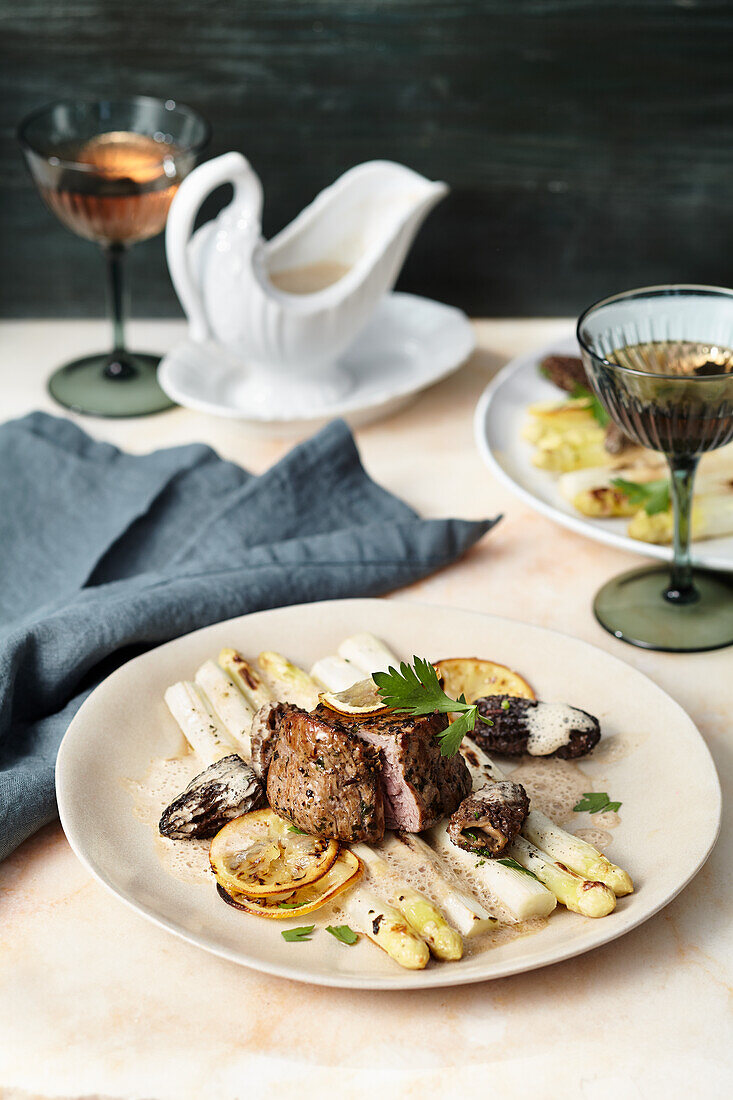 Fillet of veal with morel sauce and lemon asparagus cooked al dente