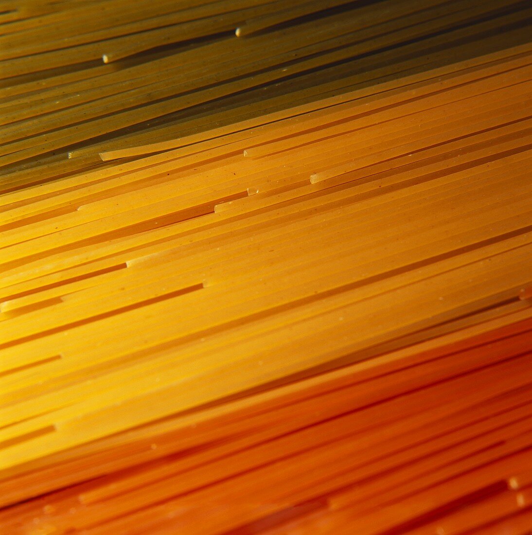 Green, yellow and red spaghetti (close-up)