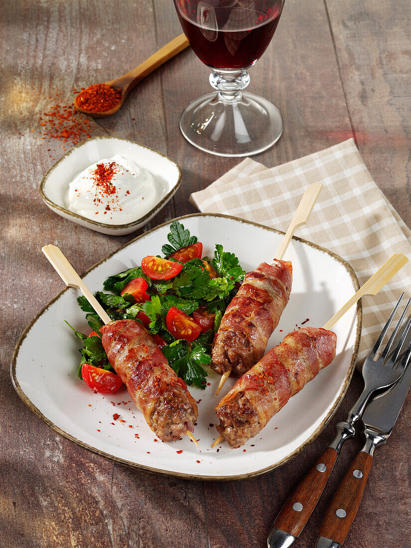 Minced meat skewers with parsley and tomato salad