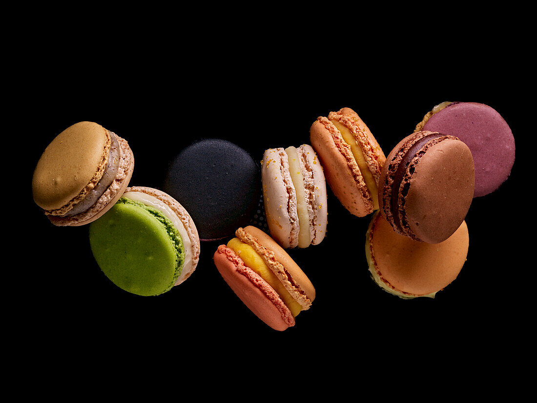 Bunte Macarons vor schwarzem Hintergrund