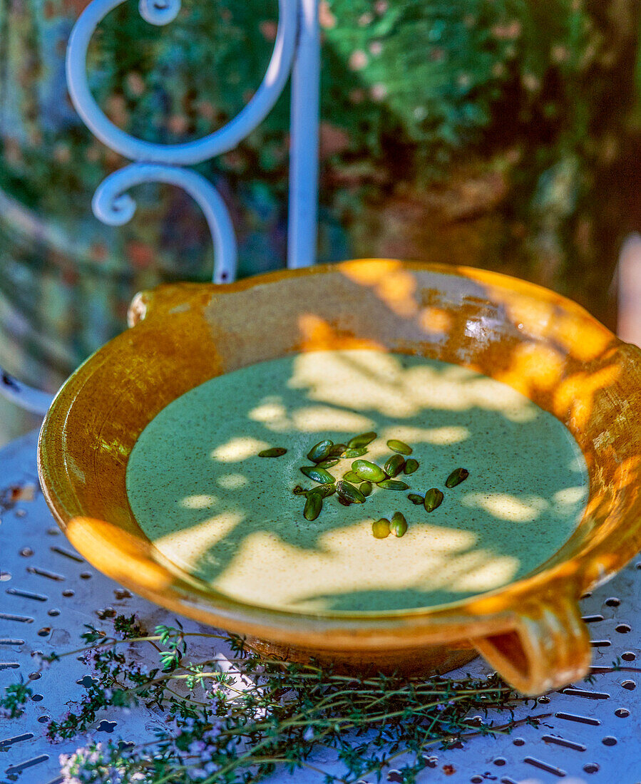 Pistachio veloute sauce on table in the garden