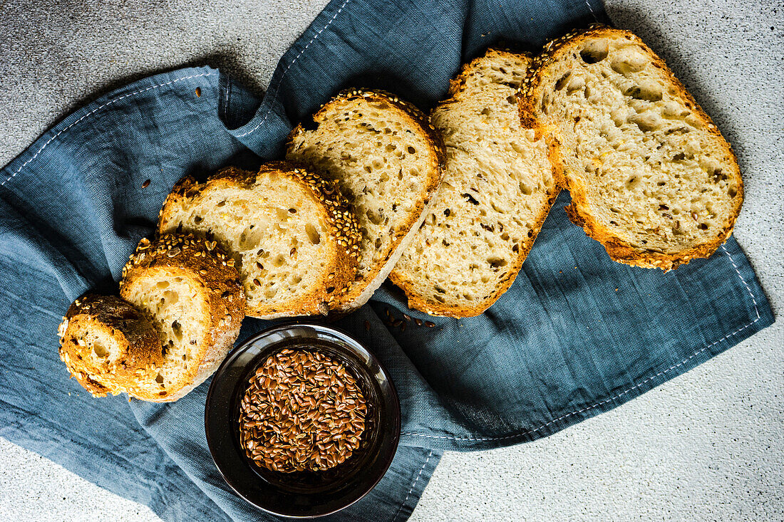 Freshly baked bread with flax seeds on a rustic towel