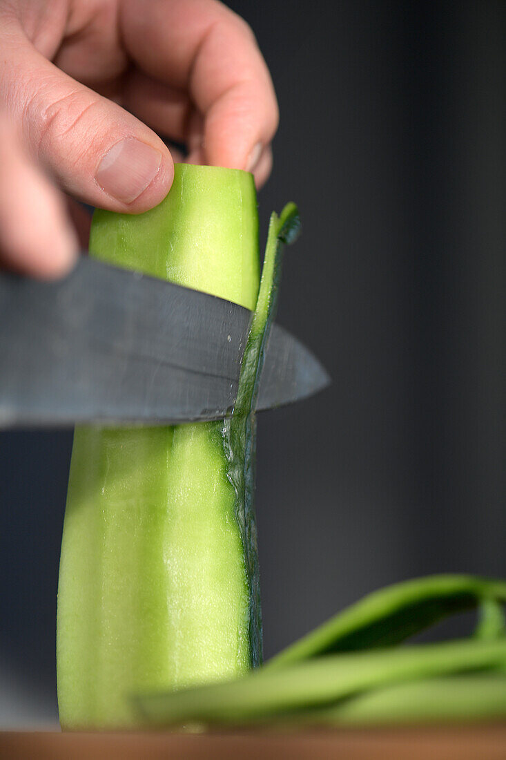 Peeling a cucumber with a knife