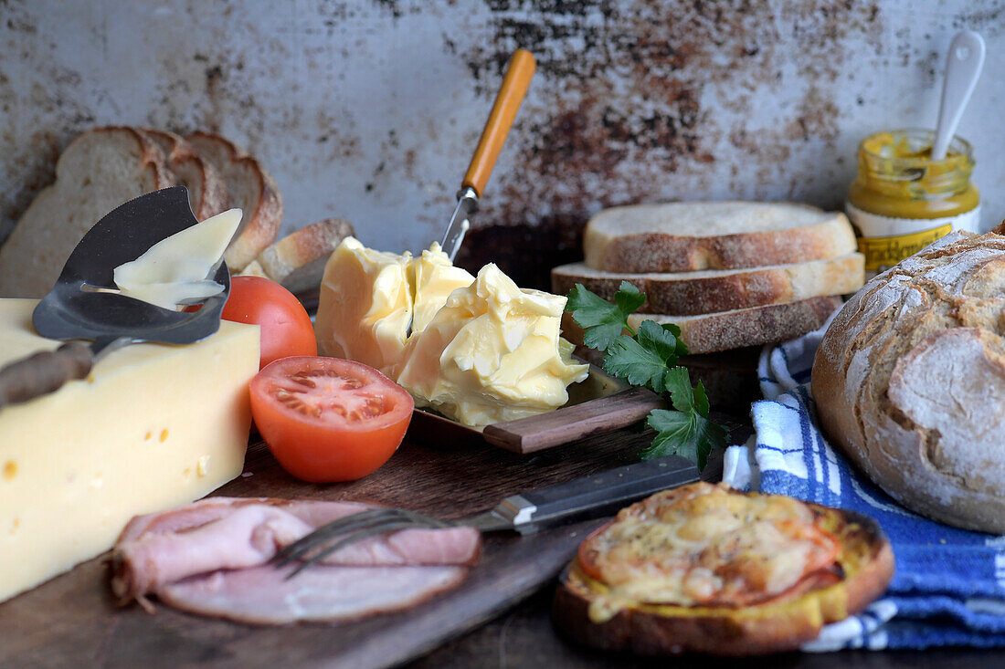 Bread, butter, cheese and ham as ingredients for sandwiches