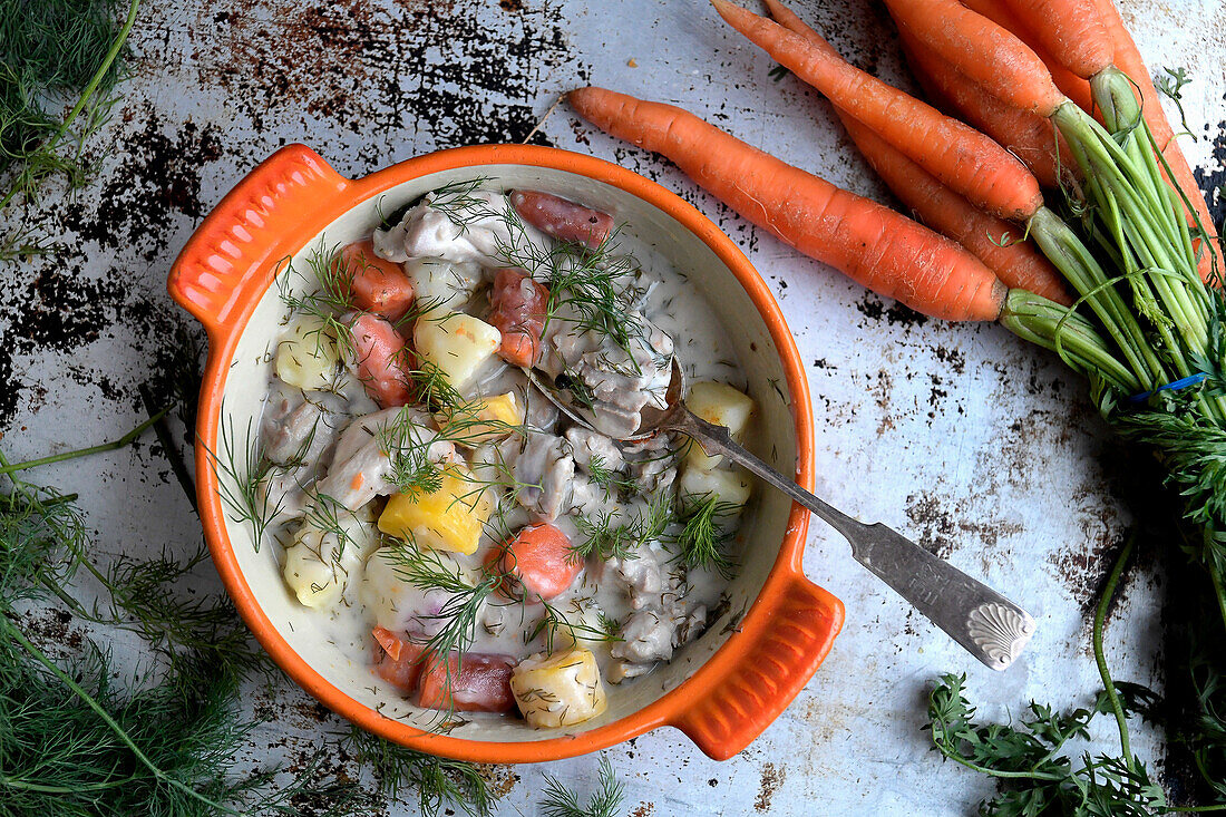 Potatoes, carrots, chicken thighs, and dill in a cream sauce