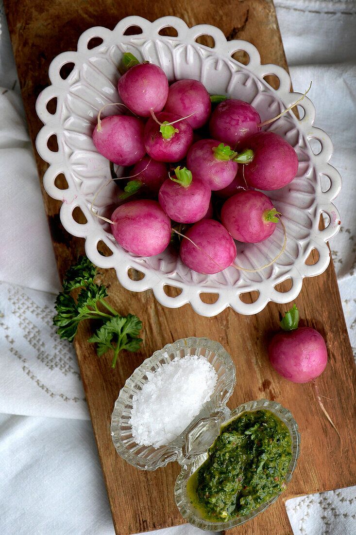 Blanched radishes in a decorative bowl served with herb chimichurri