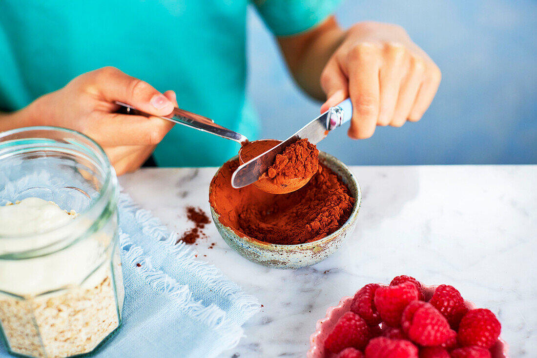 Preparing chocolate overnight oats - adding honey